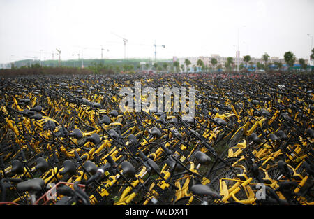 Verlassene Fahrräder der Chinesischen bike-sharing Service ofo stapeln sich auf einem Parkplatz in Nanning City, South China Guangxi Zhuang autonomen Region, 1 Apr. Stockfoto