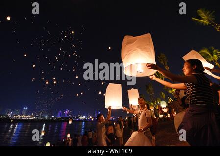 Menschen release Himmelslaternen, auch als Laternen Kongming bekannt, bei der Bank von lancang River der 1380Th neues Jahr des Dai ethnische Minderheit zu feiern. Stockfoto