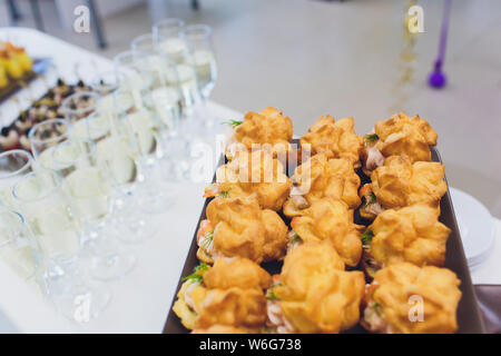 Wunderschön eingerichtete catering Bankett mit Burgern, Profiteroles, Salate und kalte Snacks. Vielzahl von leckeren Snacks auf den Tisch. Stockfoto