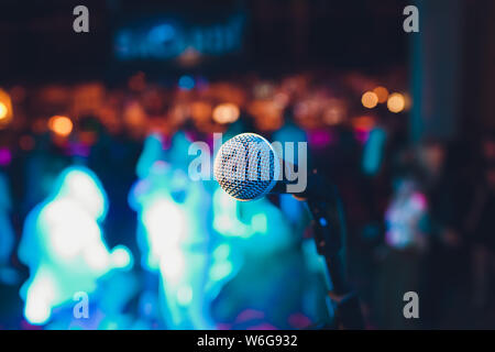 Mikrofon auf einem Stand up Comedy Bühne mit bunten Bokeh, kontrastreiches Bild. Stockfoto