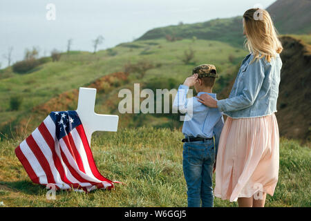 Mutter und Sohn besucht das Grab von dem Vater am Memorial Day 27. Mai Stockfoto
