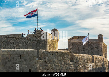 Touristen auf den Mauern eines historischen fortication mit Flagge; Dubrovnik, Grafschaft Dubrovnik-Neretva, Kroatien Stockfoto