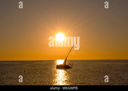 Sonnenaufgang über das Rote Meer und die Silhouette eines verlassenen Schiff in Port Ghalib, Ägypten Stockfoto