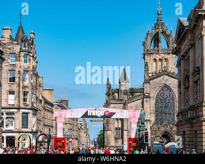 Royal Mile, Edinburgh, Schottland, Vereinigtes Königreich, 1. August 2019. Am Tag vor der offiziellen Eröffnung des Fringe Festival, das Zentrum der Stadt entlang der touristischen Route ist voll mit Besuchern. Die Franse wächst jedes Jahr und Einwohner Frage, ob weiterhin Wachstum nachhaltig ist. Die Jungfrau Geld gesponsert Straße Schauplatz bei St Giles Kathedrale Stockfoto