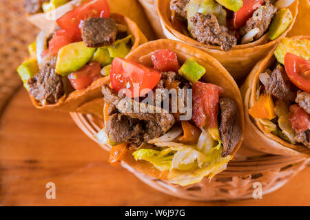 Mexikanische Rindfleisch Salat in Mais taco tortilla Kegel. Ansicht von oben Stockfoto