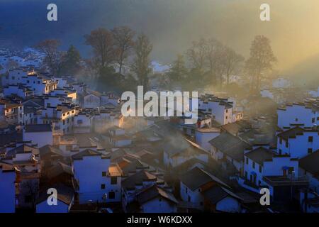 Winterlandschaft von alten Häusern mit Mau Tou Wand (Pferdekopf an der Wand) mit Rauch von Küche, Schornsteine in Wuyuan County, Stadt Shangrao, East China Ji Stockfoto