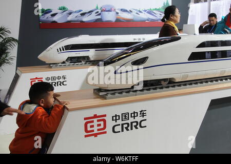 ---- Ein Besucher schaut sich das Trainieren eines Modells auf dem Display am Stand von Crrc (China Eisenbahnrollmaterial Corp Ltd) während der Expo in Wuhan City, Central Stockfoto