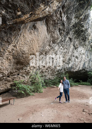 Wunderschönes junges Paar die Erkundung einer Höhle in den Bergen. Geniessen der Natur. Stockfoto