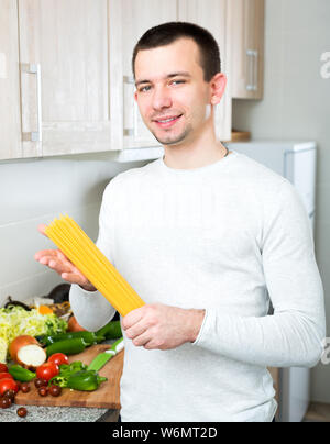 Portrait von stattlicher Mann mit Spaghetti in seiner Hand. Stockfoto