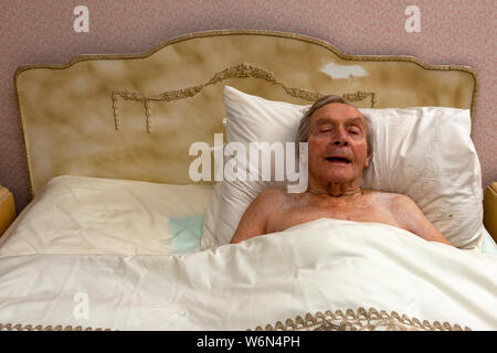 92-jähriger Mann zu sich selbst singen im Bett Stockfoto