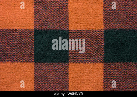 Stoff mit schwarz und orange Käfige Muster. Plaid Material. Kleidung Hintergrund Stockfoto