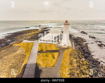 Der alte Leuchtturm Weiß auf dem Hügel gibt es steinerne Treppen um den Bereich gefüllt mit braunen Heu. Es ist ein blauer Himmel im Hintergrund. Landschaft von Stockfoto