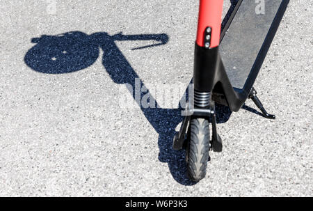 Hamburg, Deutschland. 23. Juli, 2019. Der Schatten eines Herlmes auf dem Griff eines elektrischen Pedal Roller kann an einer Vermietstation gesehen werden. Quelle: Markus Scholz/dpa/Alamy leben Nachrichten Stockfoto