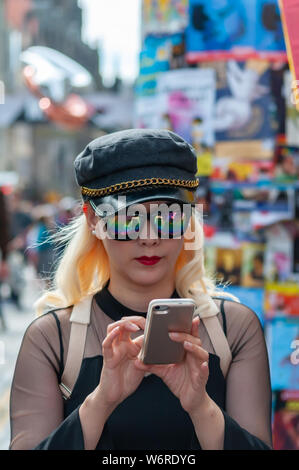 Edinburgh, Schottland, Großbritannien. 2. August 2019. Ein Mädchen auf der Royal Mile Kontrolle ihr Mobiltelefon zu Beginn des Edinburgh Fringe Festival. Credit: Skully/Alamy leben Nachrichten Stockfoto