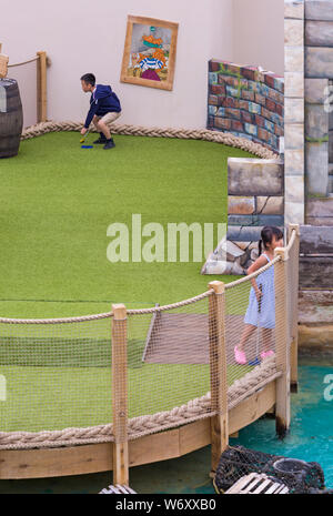 Bournemouth, Dorset UK. 3. Aug 2019. Kinder und Familien genießen das neu eröffnete Schmuggler themed Abenteuer Golfplatz, Smugglers Cove Adventure Golf, am Pier. Sie warten gespannt auf die neuen Kurs zu versuchen und mehr über die Schmuggler theme am ersten Wochenende nach der Eröffnung der Minigolfanlage am Mittwoch, den 31. Juli finden Sie heraus. Die Verwendung der erstklassigen Lage am Meer war umstritten unter den Einheimischen mit unterschiedlichen Ideen vorgeschlagen werden. Junge und Mädchen spielen Minigolf minigolf Minigolf Adventure golf Putt Putt. Credit: Carolyn Jenkins/Alamy leben Nachrichten Stockfoto