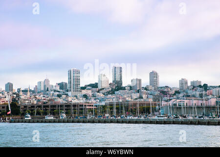 Stadt von San Francisco Kalifornien von der Bucht mit Booten, Docks, Kai und Gebäude der Skyline im Blick. Stockfoto