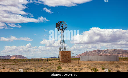 Windmühle in eine amerikanische Landschaft Wüste Landschaft, sonniger Frühlingstag, blauer Himmel mit Wolken. Stockfoto