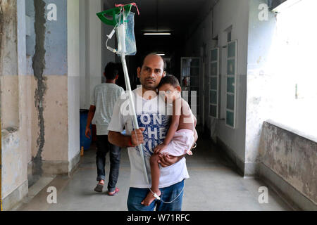 Dhaka, Bangladesch - August 04, 2019: Der Vater kuscheln einem fünf Jahre alten Dengue-fieber-Patienten in den Räumlichkeiten der Heiligen Familie Roten Halbmond medizinische Hochschule Hos Stockfoto