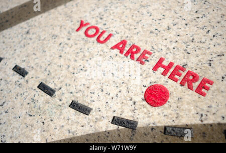 Sie befinden sich hier, Symbol auf der Karte auf dem Boden Stockfoto