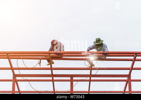 Bauarbeiter schweißen Stahl für Dachkonstruktion in Gebäude Stockfoto