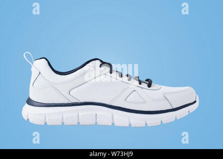 Einen männlichen weißen Turnschuhen auf blauem Hintergrund. Sport Schuh Nahaufnahme Stockfoto