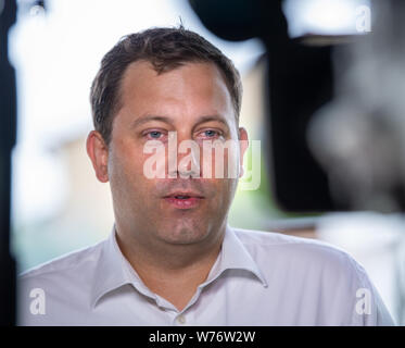 05.August 2019, Brandenburg, Jüterbog: Lars Klingbeil, SPD-Generalsekretär, gibt ein Interview auf einer Presseveranstaltung auf der Tür-zu-Tür Wahlkampf in der werderschen Siedlung. Foto: Monika Skolimowska/dpa-Zentralbild/dpa Stockfoto