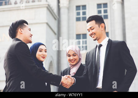 Geschäftsleute, die Hand schütteln, vor Bürogebäude, multirassischen Geschäftskonzept. Stockfoto