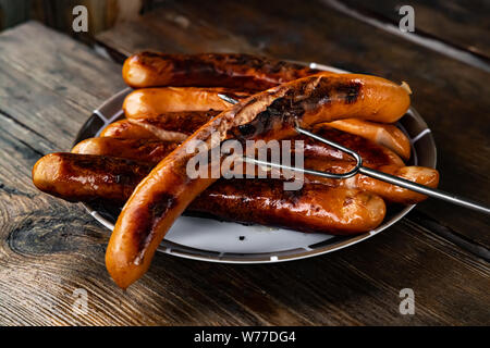 Gegrillte Würstchen auf Holzbrett Stockfoto