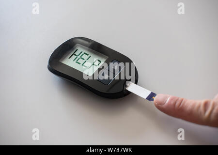 Glucometer bittet um Hilfe nach der Messung des Blutzuckers: Konzept der Hyperglykämie Stockfoto