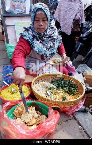 Eine Frau Street Food Unternehmer bereitet die Bestellung Ihres Kunden. Stockfoto