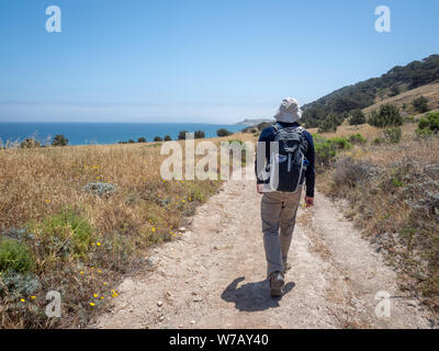 Wanderer zu Fuß auf dem Weg, Wasser Canyon Strand, Küstenstraße, in der Nähe der Ranch zu Bechers Bay Pier an einem sonnigen Frühlingstag, Santa Rosa Island, Channel Islands Nati Stockfoto