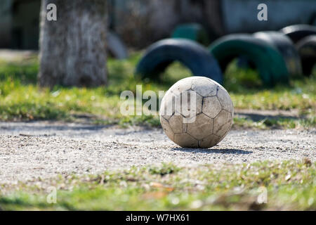 Alte schäbige Leder Fußball auf dem Boden liegend Stockfoto