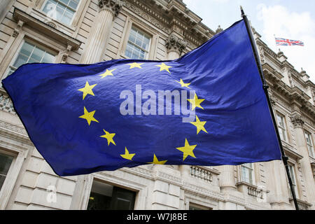 Ein anti-Brexit Demonstrant Wellen der Flagge der EU außerhalb des Cabinet Office in Whitehall, London. Stockfoto