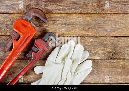 Industrielle Schutzhandschuhe, Schlüssel, Stahl auf dem Tisch Werkzeuge sanitär Zubehör Stockfoto