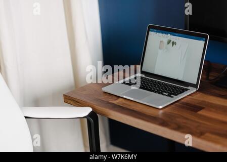Nahaufnahme eines Laptops auf einem Holzschreibtisch Stockfoto