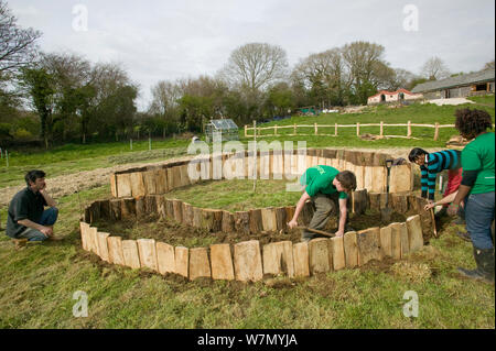 Die jungen Freiwilligen Hilfe angesprochen, die Betten für den Anbau von Lebensmitteln, auf die Erde Umweltprojekt, Murton, Gower, South Wales, UK 2009 erstellen Stockfoto