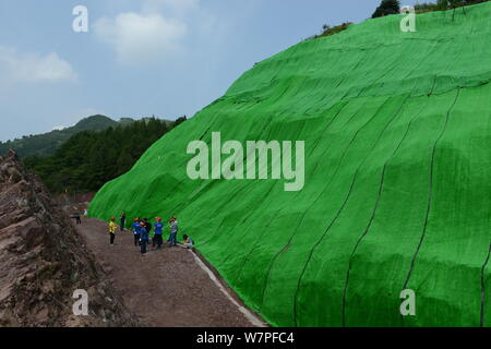 Blick auf die Ausgrabungsstätte von dinosaurierfossilien in einer Wand 150 Meter lang, 2 Meter tief und 8 Meter hoch, im Dorf Laojun, Pu'eine Stadt konzentriert Stockfoto