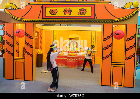 Ein cartoon Enthusiast nimmt ein Foto mit Gudetama, oder faul Ei, von Hello Kitty's Entwickler Sanrio, in Shanghai, China, 19. Juni 2017 erstellt. Die Japa Stockfoto