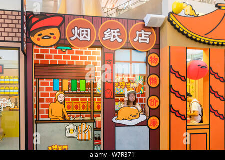 Ein cartoon Enthusiast nimmt ein Foto mit Gudetama, oder faul Ei, von Hello Kitty's Entwickler Sanrio, in Shanghai, China, 19. Juni 2017 erstellt. Die Japa Stockfoto