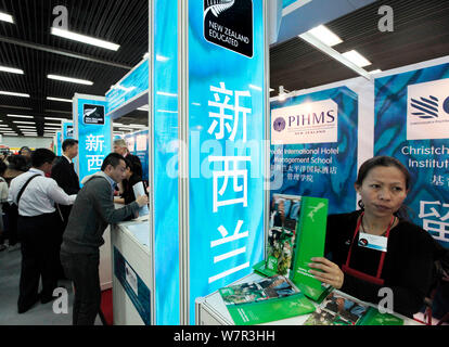 ------ Chinesischer Besucher sprechen mit Ausbildung Berater an den Ständen der Neuseeländischen Universitäten während einer Bildungsmesse in Peking, China, 23 Oc Stockfoto