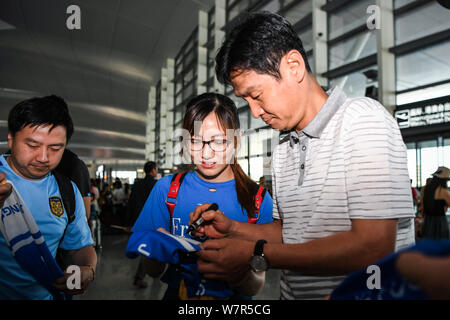 Ehemaliger Haupttrainer Choi Yong-soo von Jiangsu Suning, rechts, Beschilderung ein Autogramm für einen Fan vor der Rückkehr nach Südkorea an der Nanjing Lukou Internatio Stockfoto