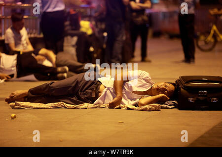 Die Passagiere schlafen auf dem Platz von Zhengzhou Bahnhof in Zhengzhou City, Central China Provinz Henan, 18. Mai 2017. Hunderte von passenge Stockfoto