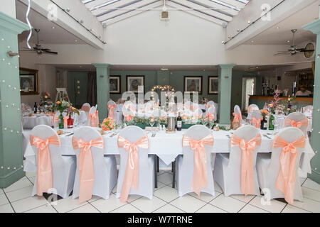 Hochzeit kein Zimmer mehr mit Leuten, die alle von der Tabelle Dekorationen der Paare Hochzeit in Pfirsich und Grün angezeigt, Hochzeit in England Stockfoto