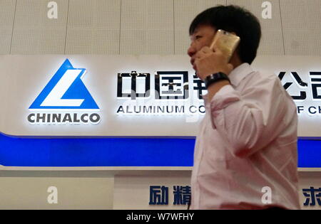 ---- Einen Fußgänger an der Tafel von Chinalco (Aluminium Corporation of China), die Muttergesellschaft von Chalco (Aluminium Corporation of China Lim Stockfoto