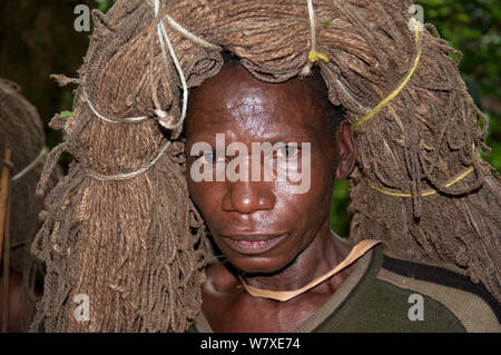 Mbuti Pygmy Mann werfen net auf den Kopf für die Einleitung Jagd, Ituri Rainforest, Demokratische Republik Kongo, Afrika, November 2011. Stockfoto