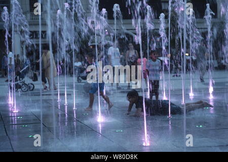 Juli 2019 wurde der Erde heißeste Monat auf Aufzeichnung, schlagen oder Binden, Juli 2016. Тhe Hitzewelle die kinder cool in den Brunnen der Stadt. Stockfoto