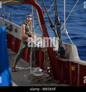 Mann Trimmen der Segel an Bord, corwith Cramer, eine 134-Fuß-Stahl brigantine gebaut als ein Forschungsschiff. Sargassosee, Bermuda, April 2014. Stockfoto