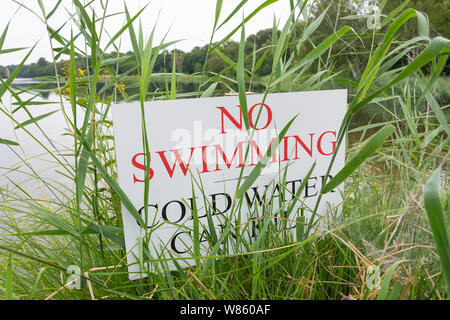 'Kein Schwimmbad, kalte Wasser kann töten"-Schild an der Küste von Virginia Wasser See im Sommer, Windsor Great Park, Runnymede, Surrey, England, Vereinigtes Königreich Stockfoto