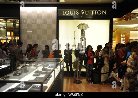 Chinesische Kunden Schlange vor einer Boutique Louis Vuitton (LV) im Kaufhaus Galeries Lafayette während der 2016 'Les Soldes' Sommer Stockfoto