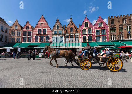 Brügge, Flandern, Belgien: Fassade des traditionellen flämischen Gebäuden auf dem Hauptplatz Markt ('Markt') Strassencafés und Pferdekutschen. Stockfoto